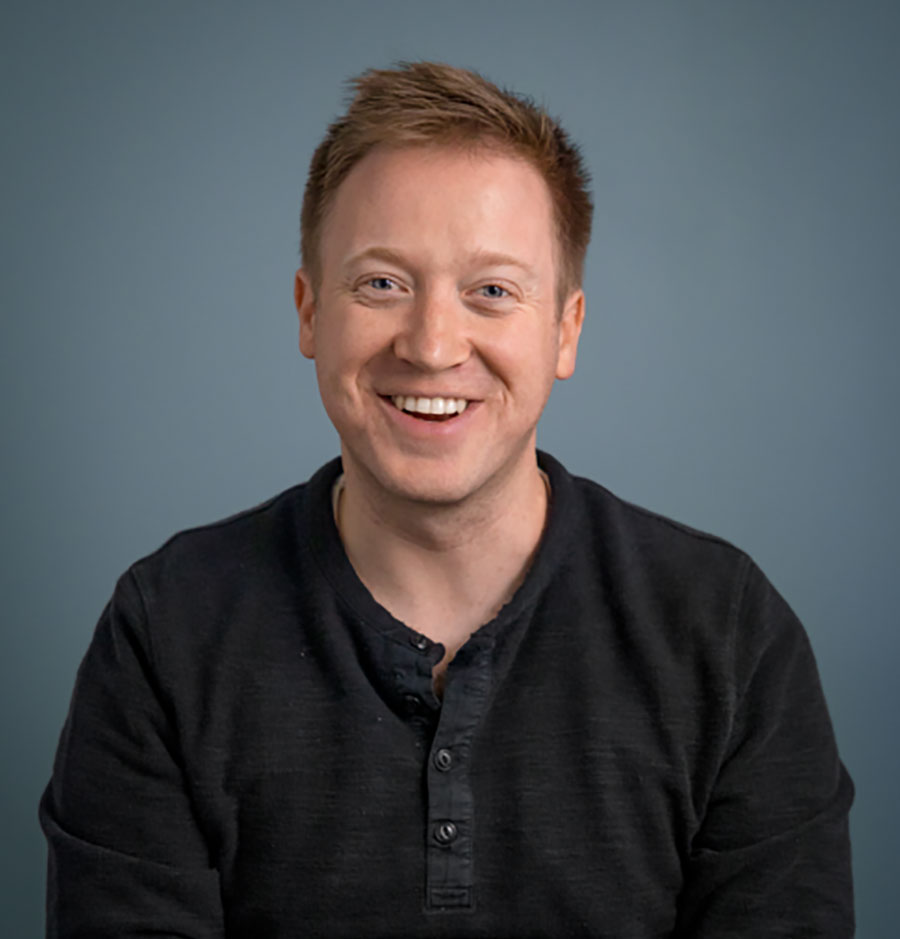 BloomTech co-founder and CEO Austen Allred against a blue-gray background
