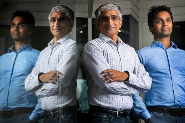 Venky Soundararajan and nference co-founder Murali Aravamudan standing beside a reflective glass wall