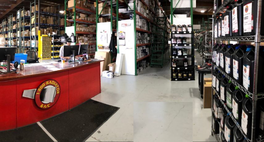 A 1-800 Radiator parts counter backed by tall shelves of boxed inventory and automotive fluids