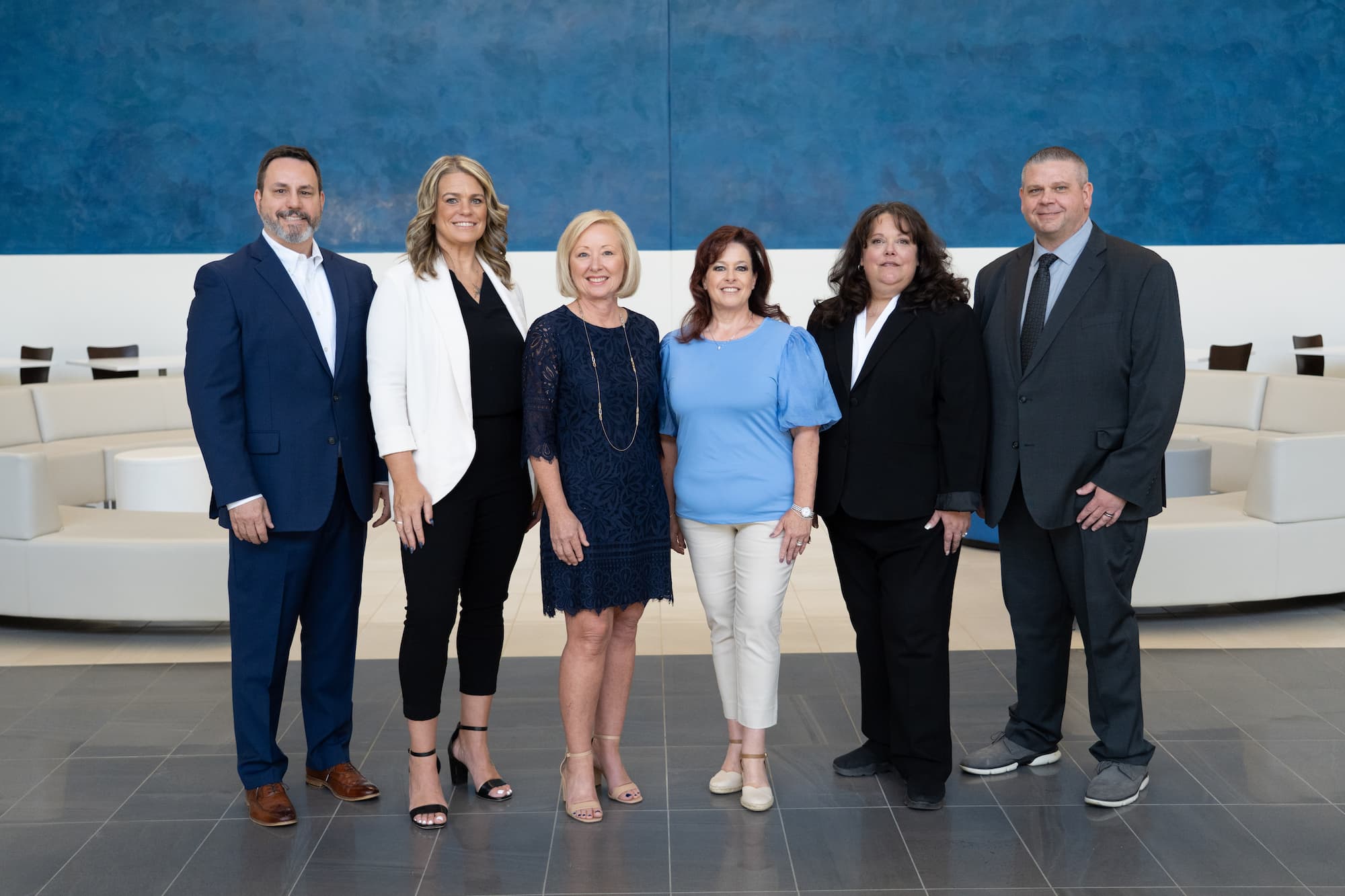Six 12 Oaks team members standing together in a meeting space