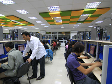 123Employee office photograph showing staff at computers beneath green and yellow ceiling panels