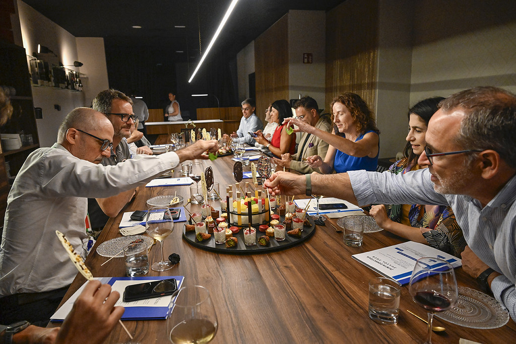 Members of the 22@Network Barcelona board gathered around a table, sharing food and conversation