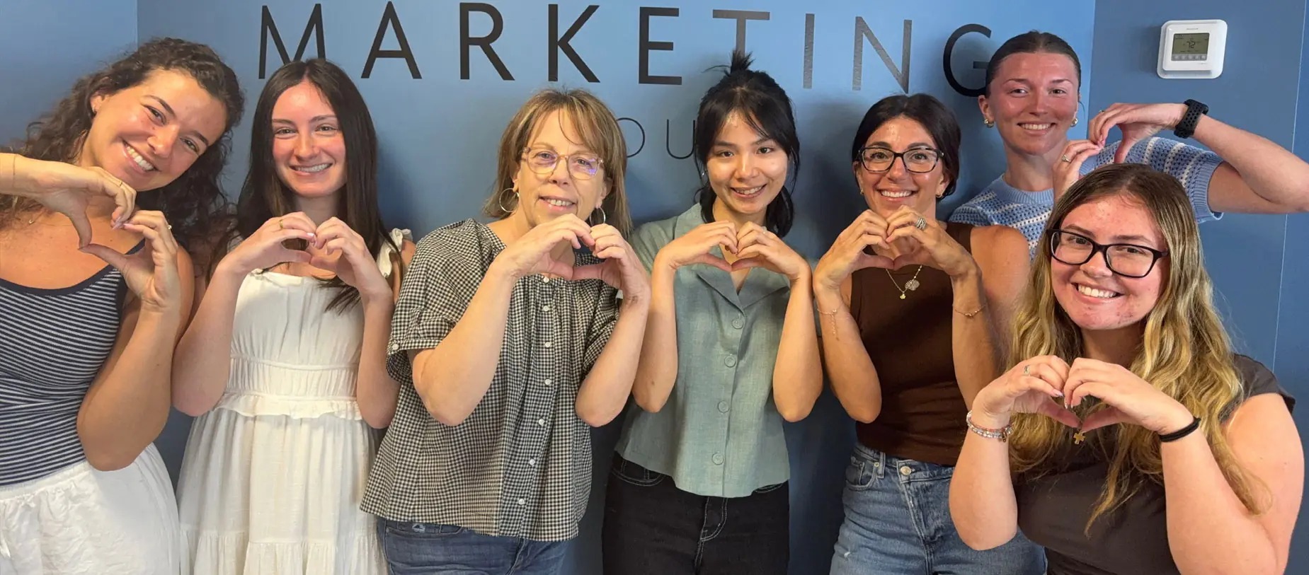 Members of the 23 Marketing Group team standing together in their office