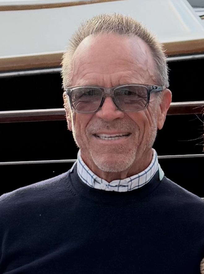 24/7 Media co-founder David J. Moore wearing glasses and a navy sweater