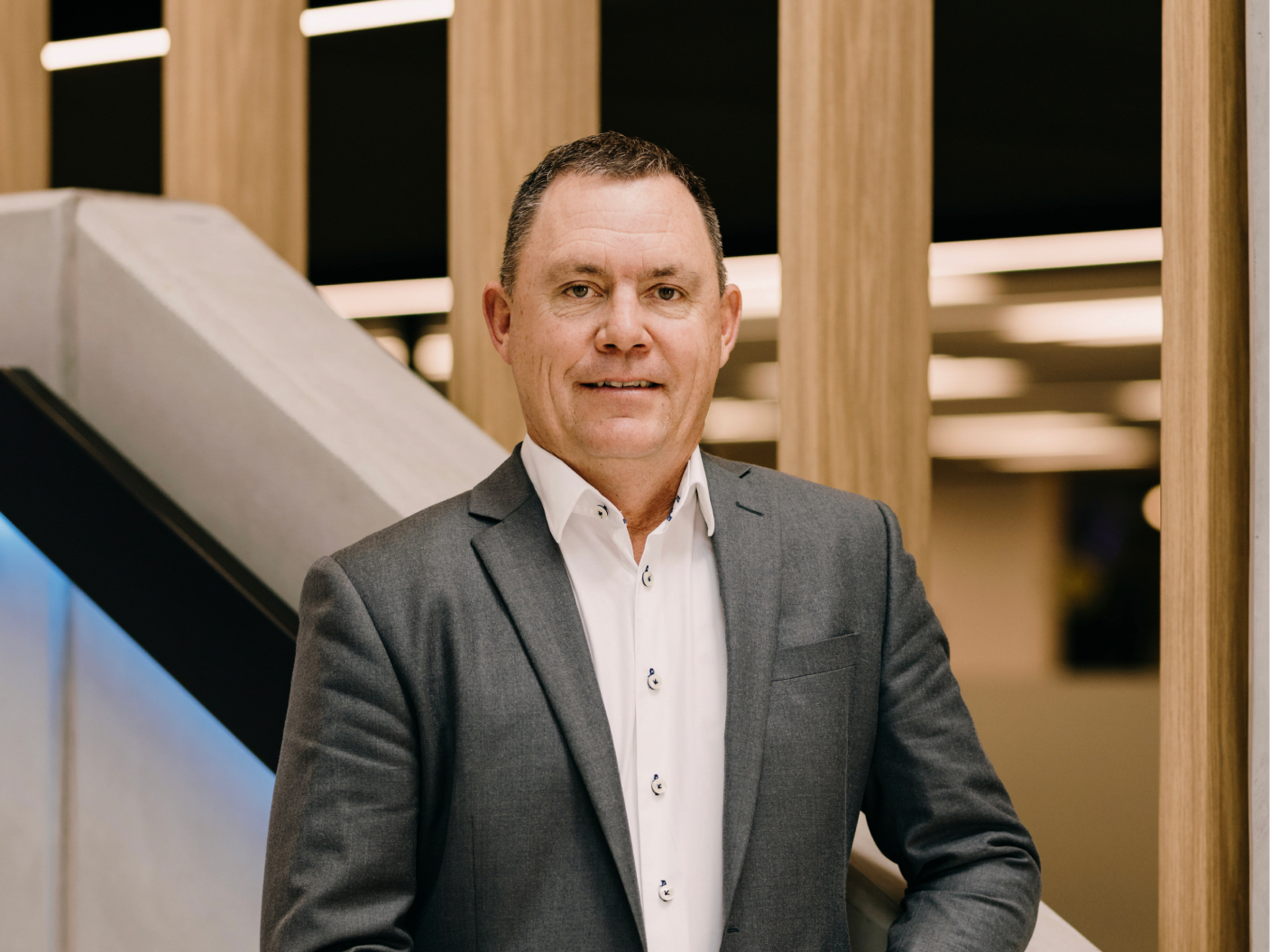 2degrees chief executive Mark Callander standing beside the stairs at head office