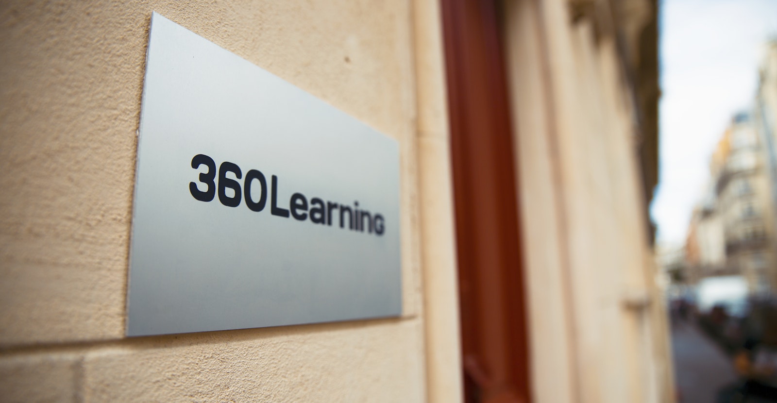 A 360Learning sign mounted outside the company's office