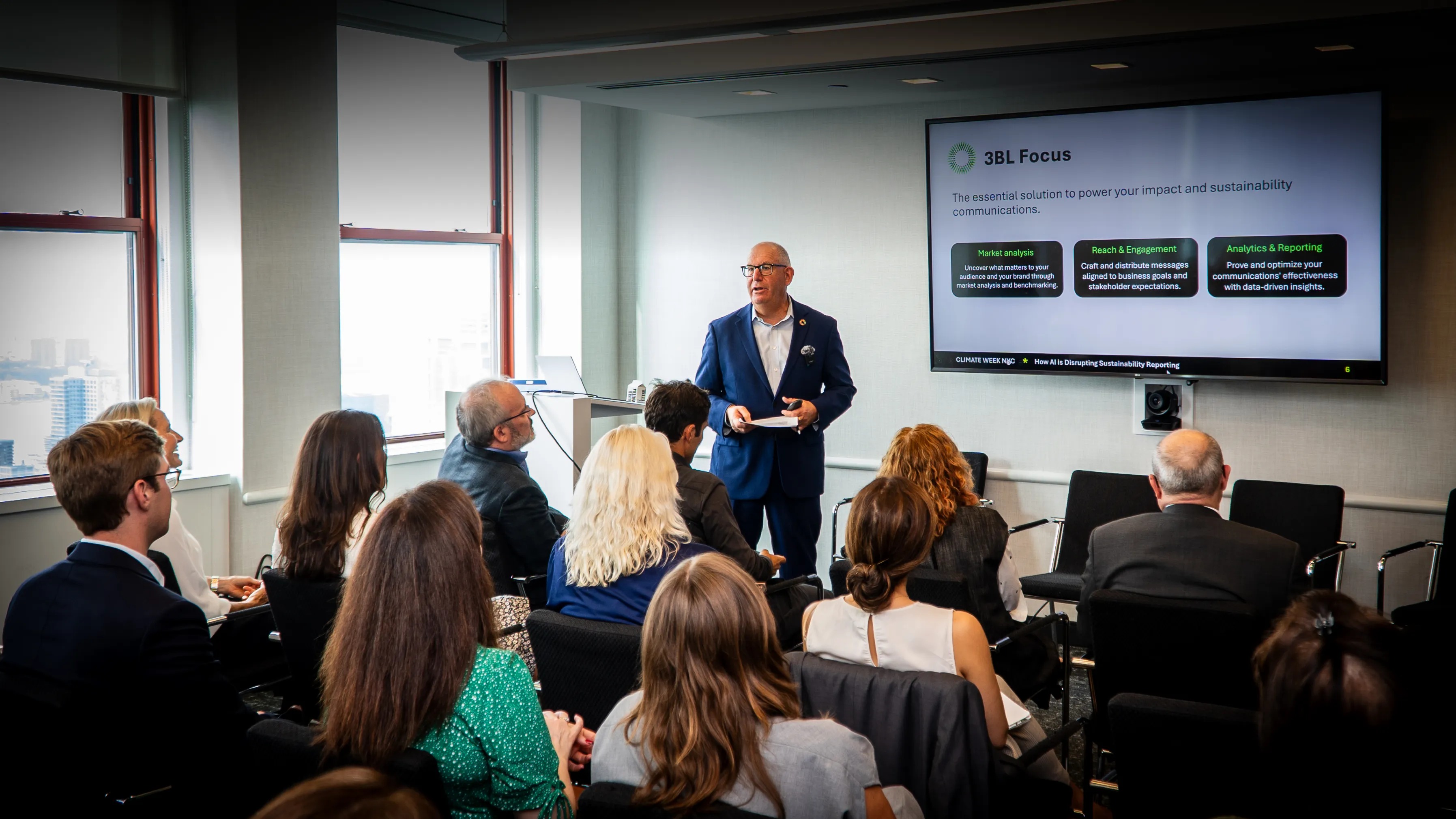 A 3BL Focus presentation to a seated audience in a conference room