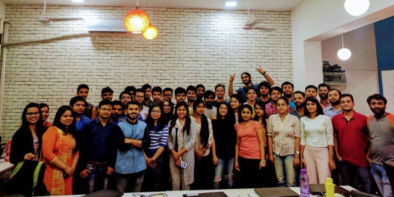 The 3.14 Digital team gathered in an office in a photograph published in 2017