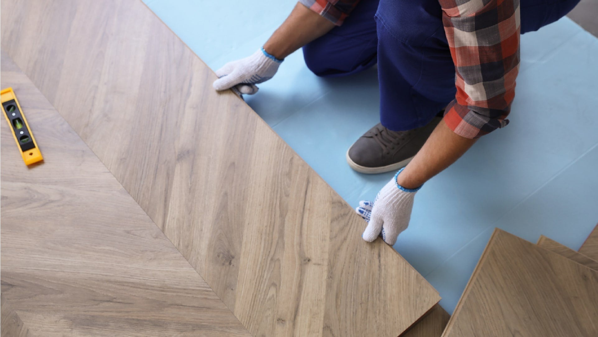 An installer fitting a wood-effect floor panel