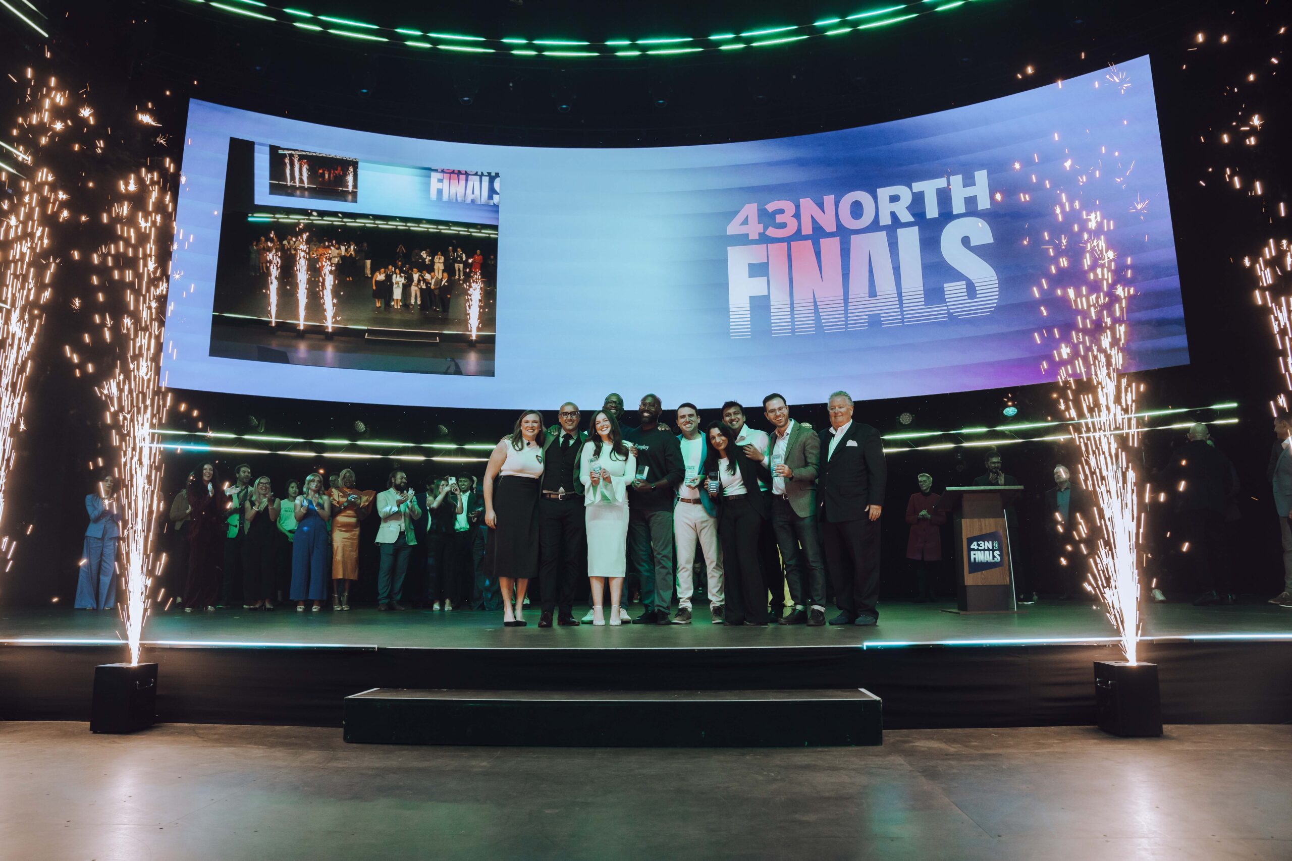 Founders and organizers celebrating on the 43North Finals stage in 2025