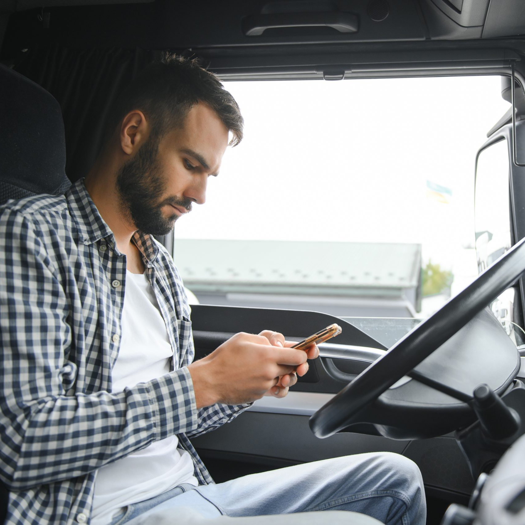 Driver using a mobile phone in company imagery illustrating FastPass communication