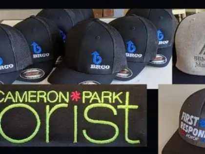 Rows of embroidered caps made for local organizations