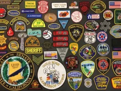 A collection of public service, school, and organization patches