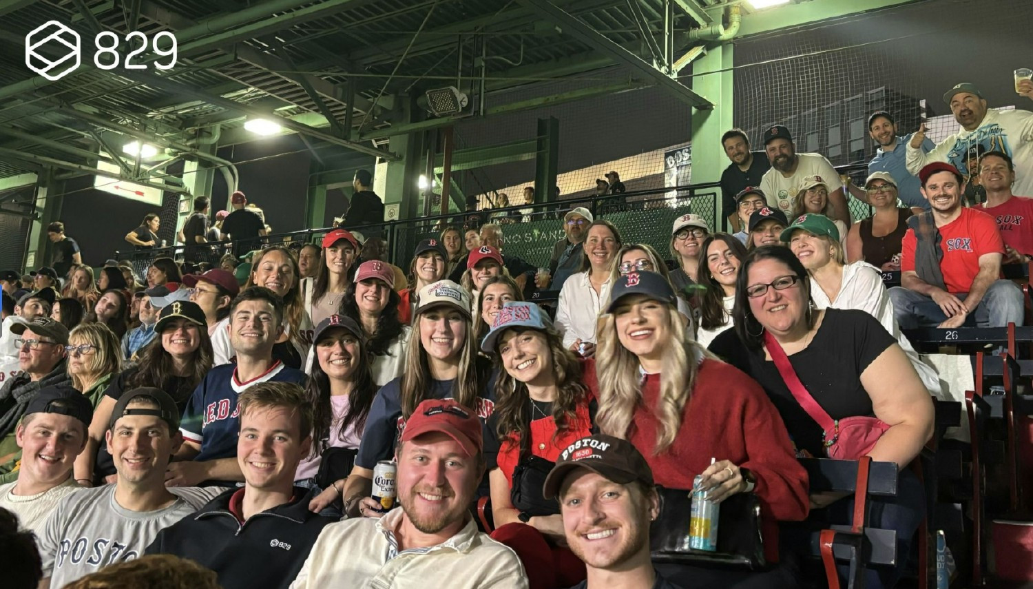 829 Studios colleagues wearing Red Sox caps at the company’s annual baseball outing