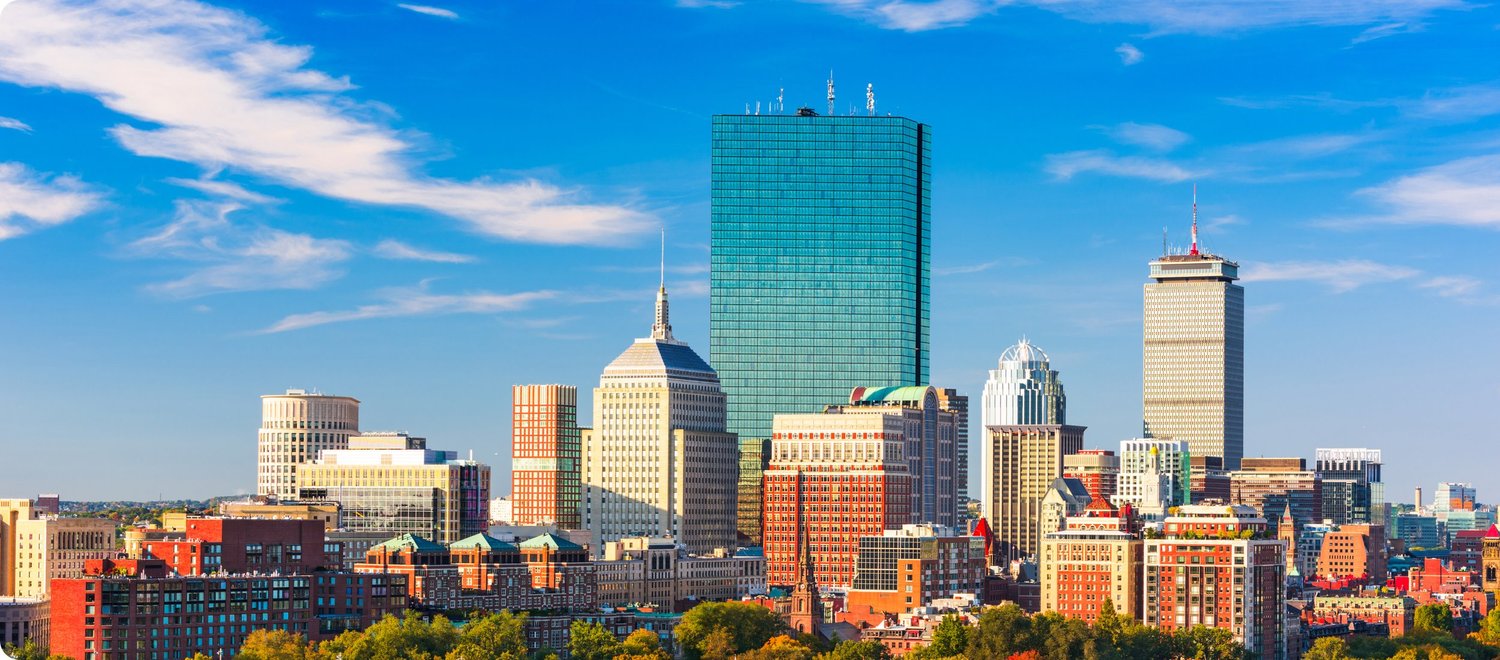 Boston skyline under a bright blue sky