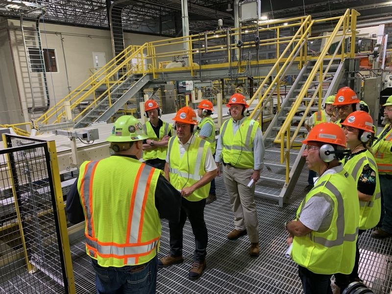 James Hardie leaders and employees touring the Prattville manufacturing plant in hard hats and high-visibility vests