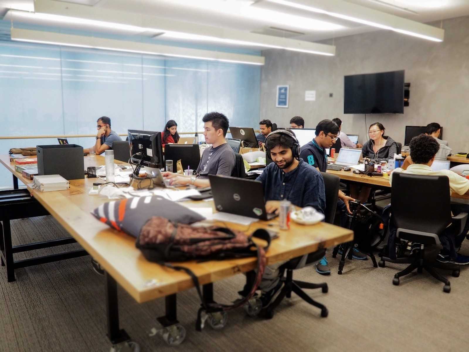 Aaron Lim and colleagues working at desks in a Privyr office