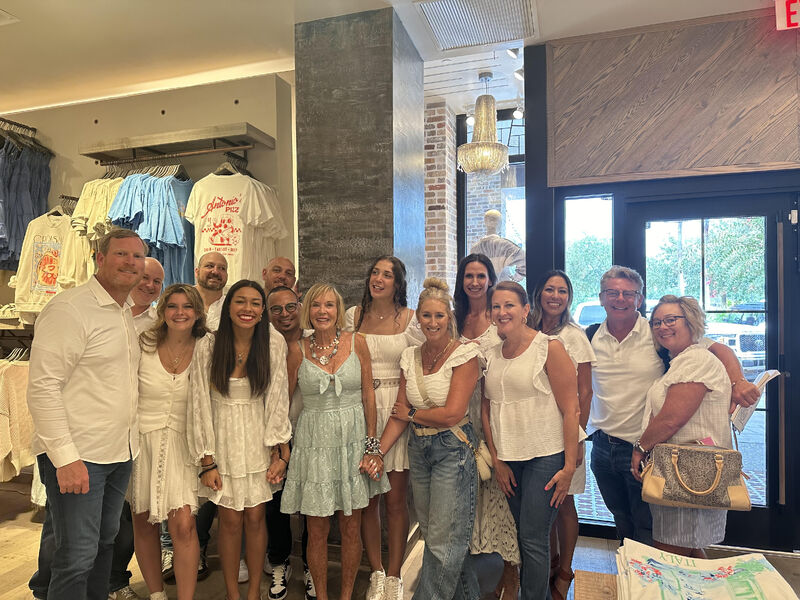 Aaron Walters at left with Altar’d State associates and guests inside the Destin store