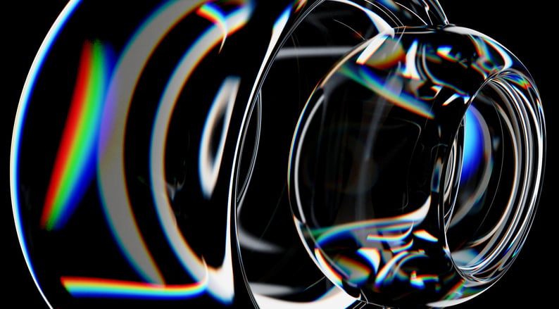 Abstract glass lenses refracting bands of color against a dark background