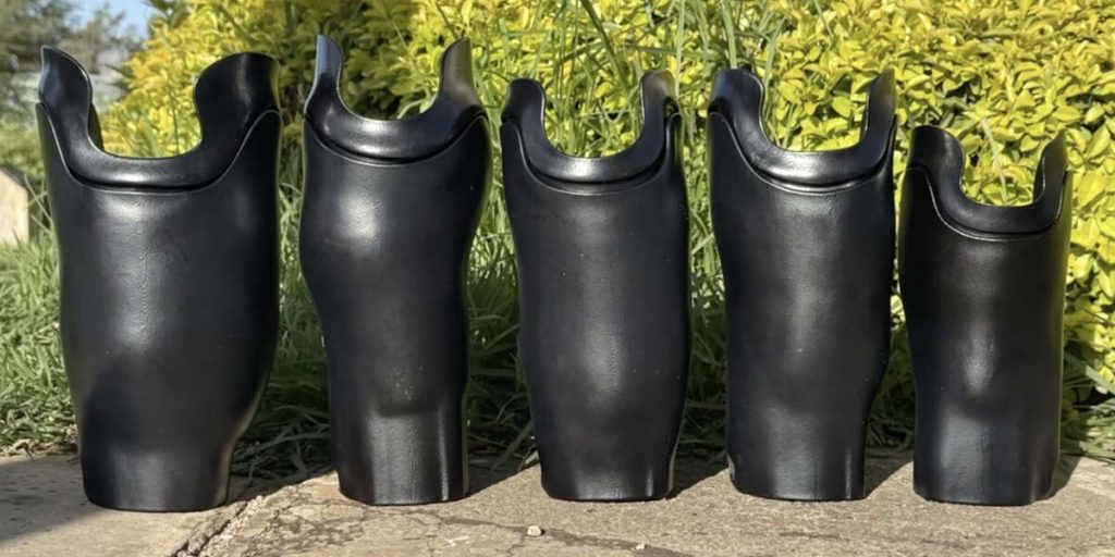 Five black custom prosthetic sockets made through ABCorp’s Limb Kind collaboration