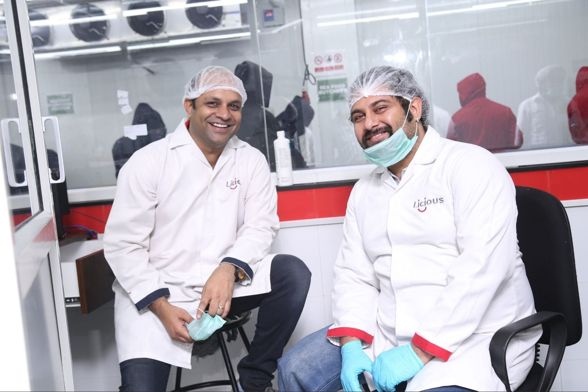 Vivek Gupta, left, and Abhay Hanjura in protective clothing inside a Licious processing facility