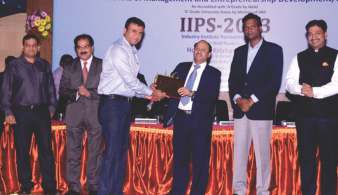 Abhijit Gangoli being felicitated by Dr. Shivajirao Kadam at IIPS 2013