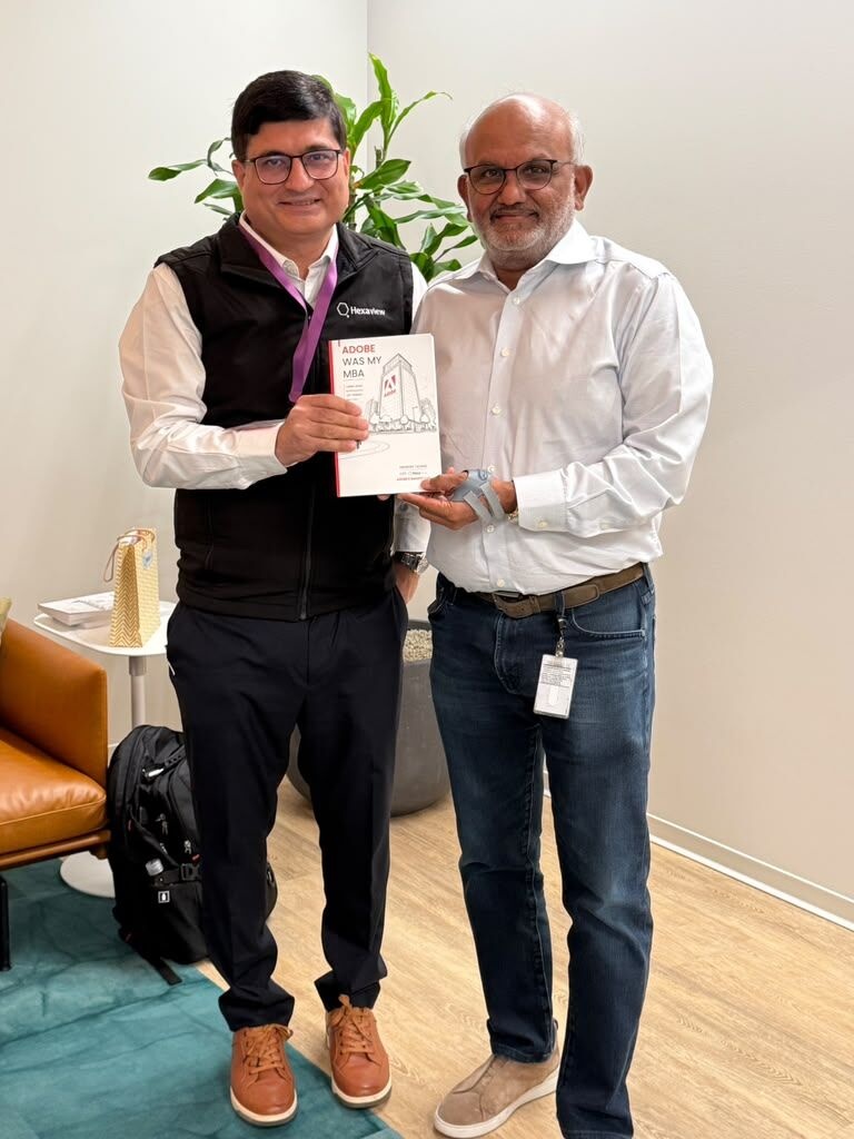 Abhishek Talwar, left, and Shantanu Narayen holding Adobe Was My MBA