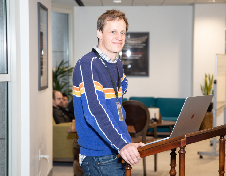Academia.edu founder Richard Price speaking at a podium in the company's office