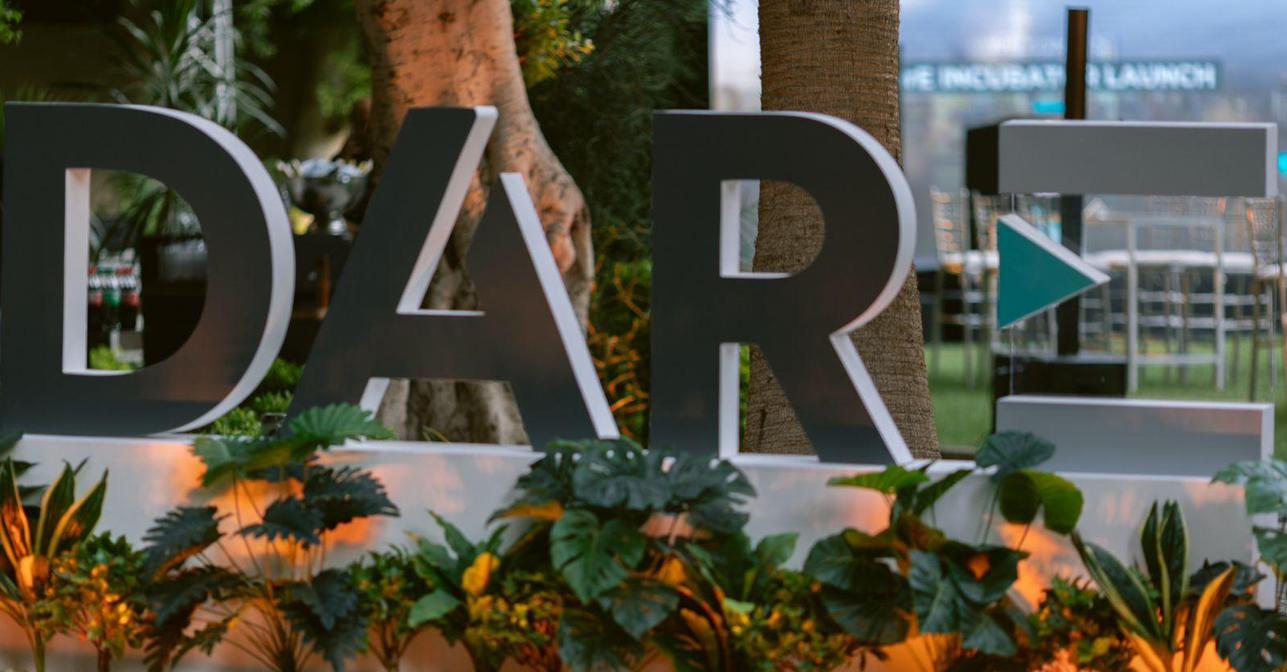 Large DarE lettering among plants at the incubator launch