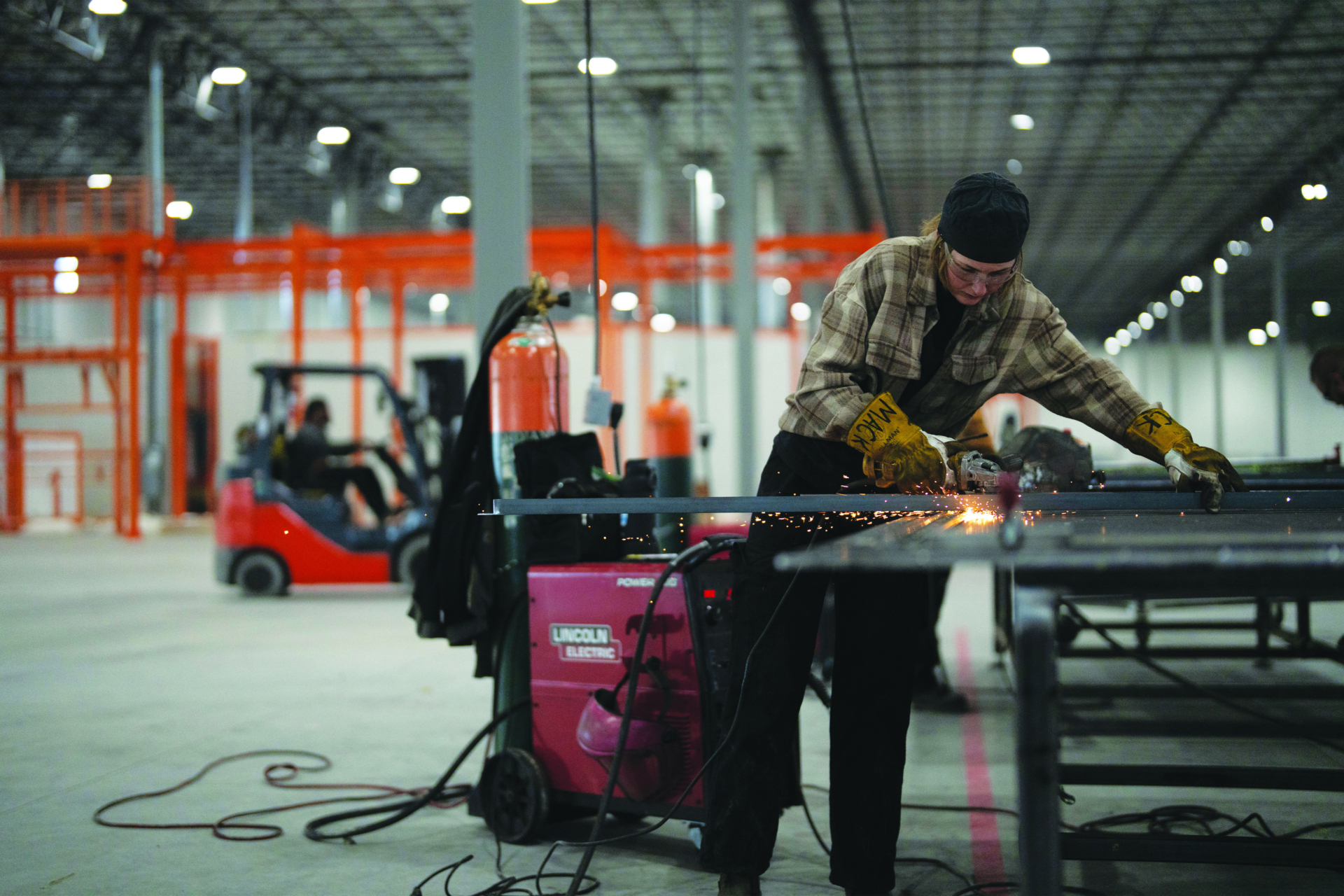 An Accelevation worker fabricates steel inside a manufacturing facility