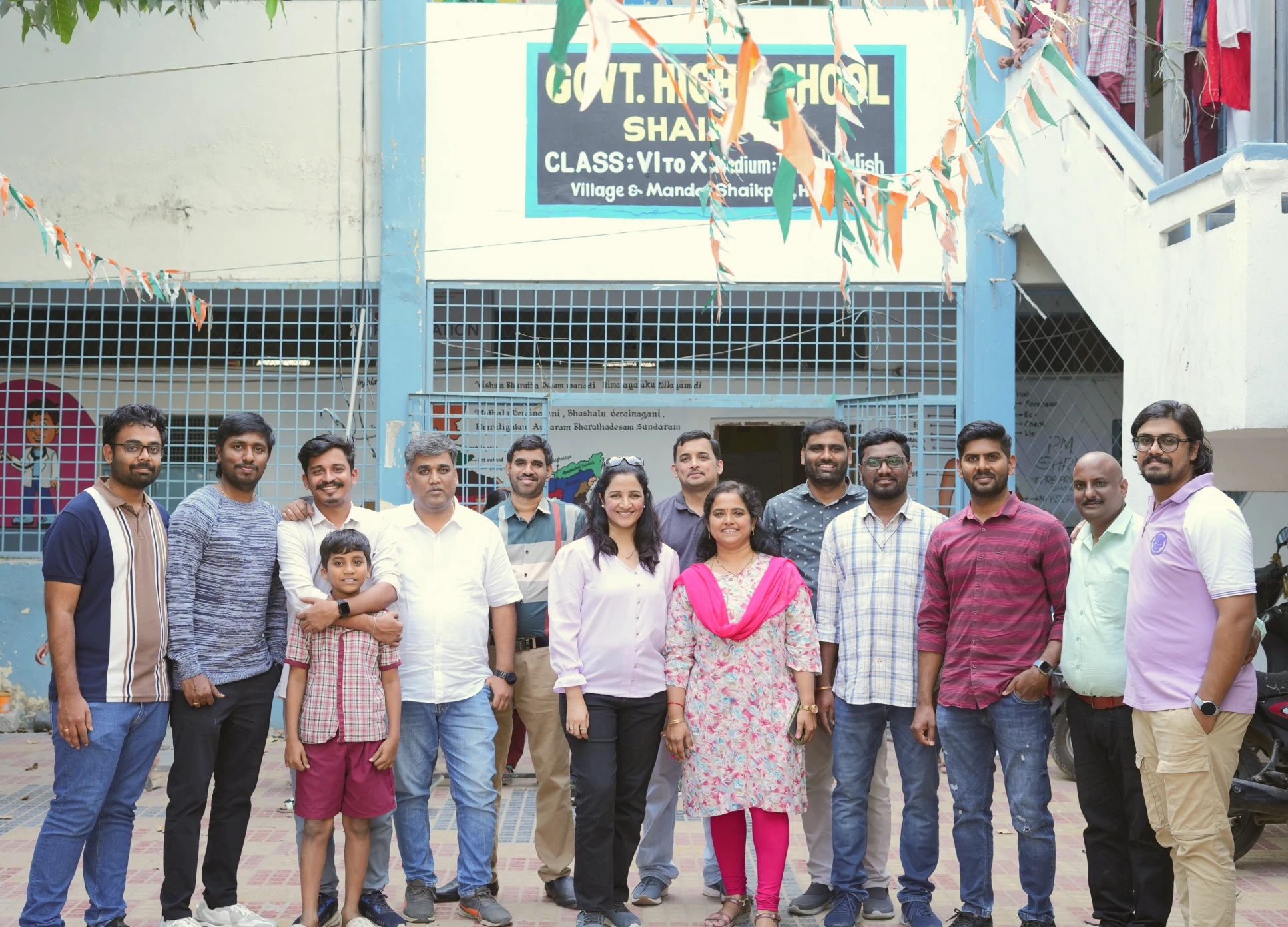A group pictured outside a school in Accellor's community education program