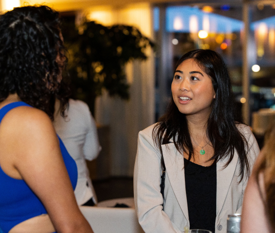 Two people in conversation in a photograph from Access’s careers page