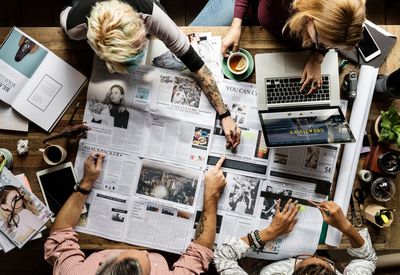 Communications professionals collaborating around a table