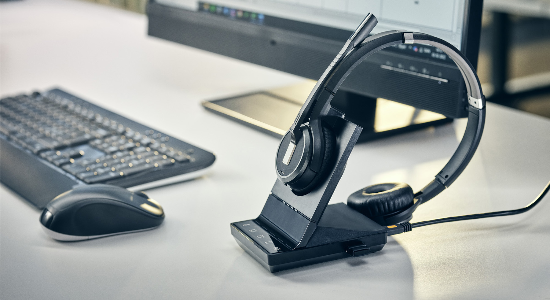 EPOS enterprise headset on a desk beside a laptop