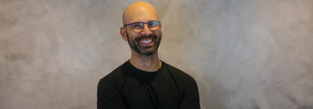 ACE co-founder Pedro Waengertner smiling in a black shirt and glasses