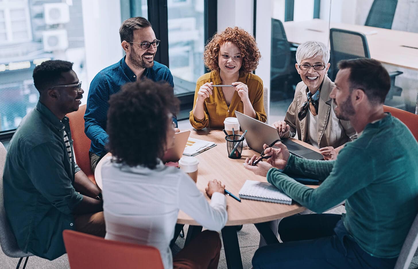 A collaborative meeting pictured in ACI’s careers promotional photography