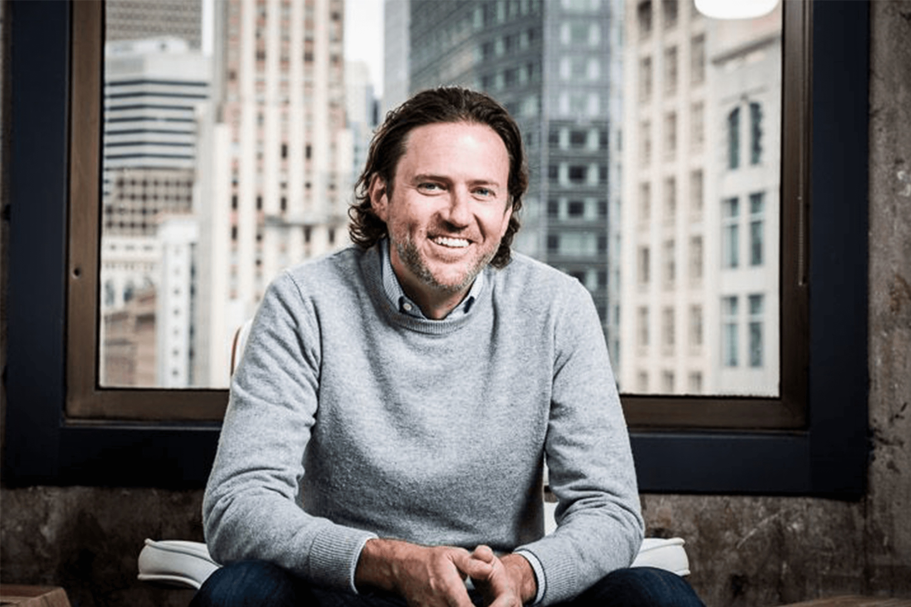 ACME co-founder Scott Stanford seated by an office window