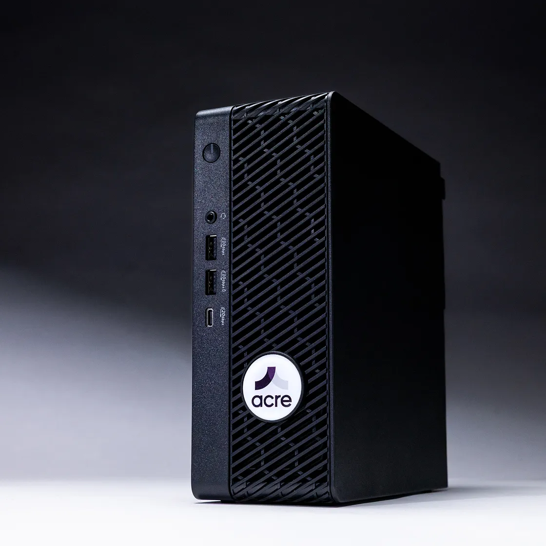 Acre Bridge hardware, a compact black computer with a vented front panel