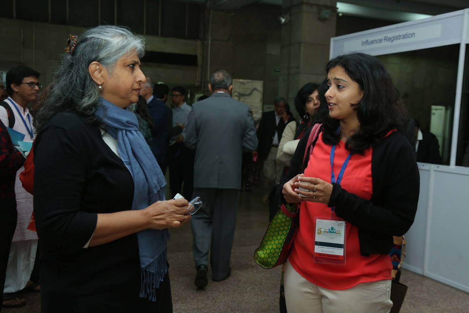Two participants in conversation at an Action For India forum