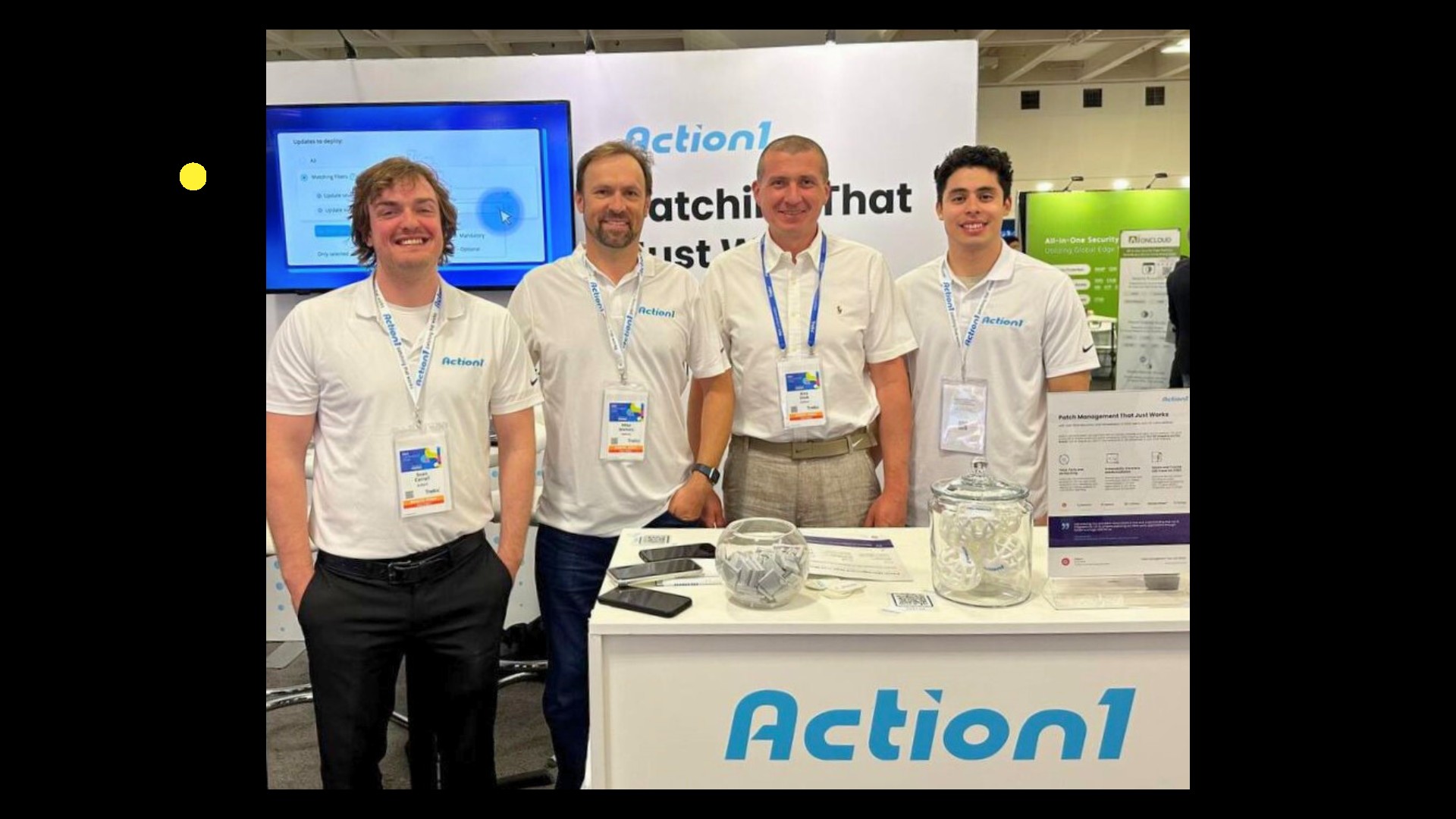 Four Action1 team members at the company's Microsoft Ignite 2024 booth