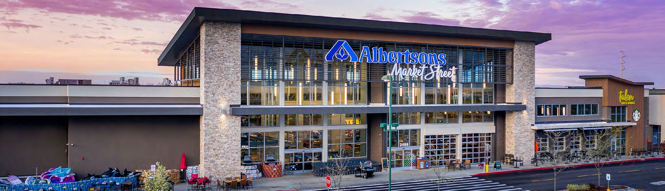 Albertsons Market Street supermarket beneath a pink evening sky