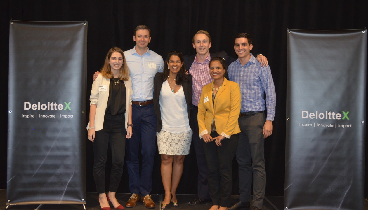 Six presenters at the 2016 DeloitteX event in Austin, standing between event banners