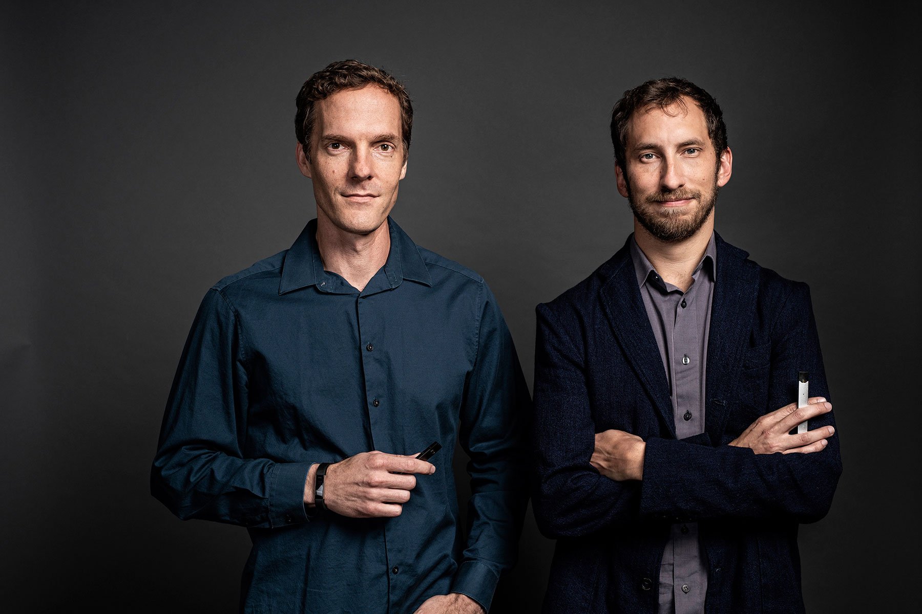 Adam Bowen and James Monsees standing against a dark studio background