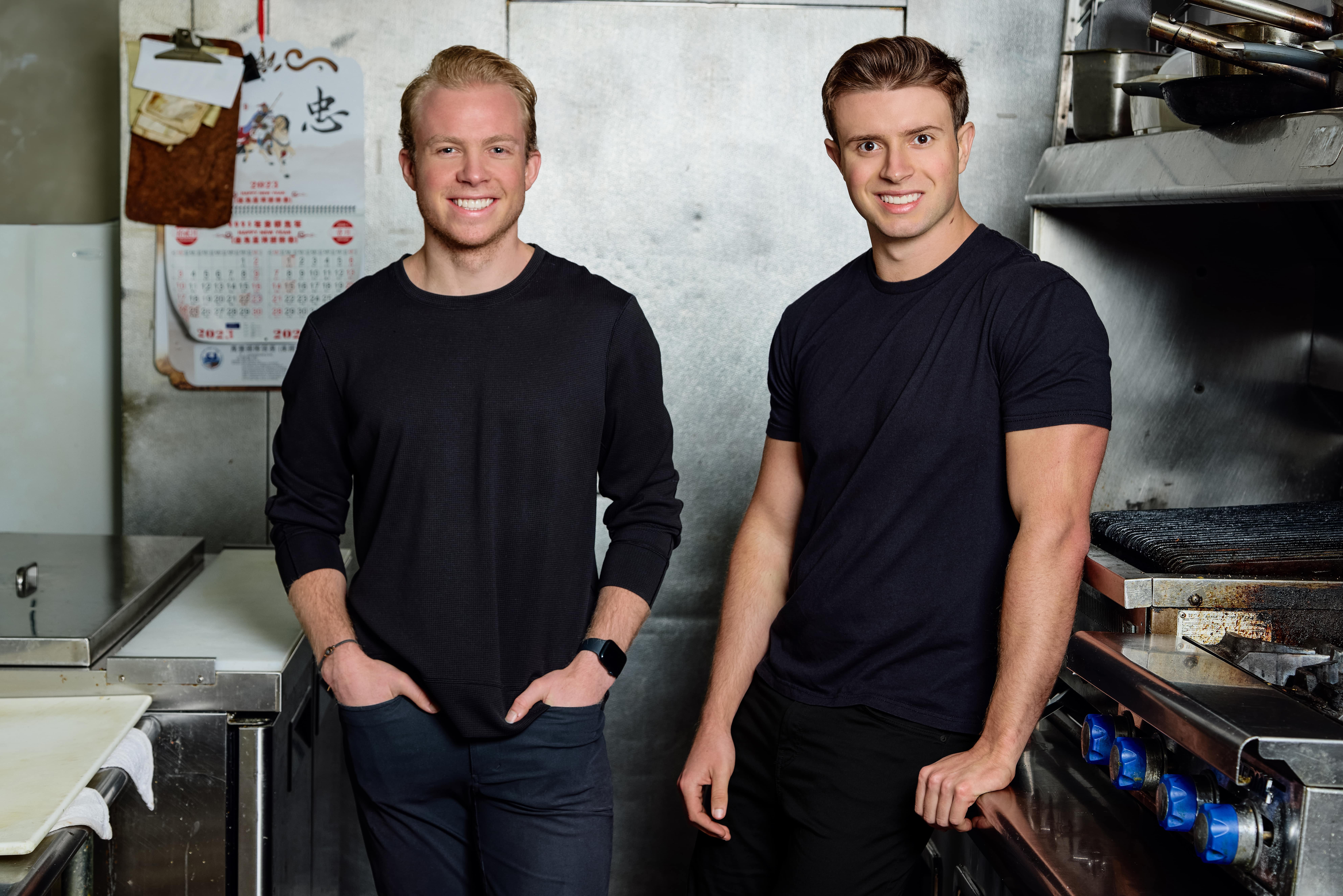 Dean Bloembergen, left, and Adam Guild, right, standing in a restaurant kitchen