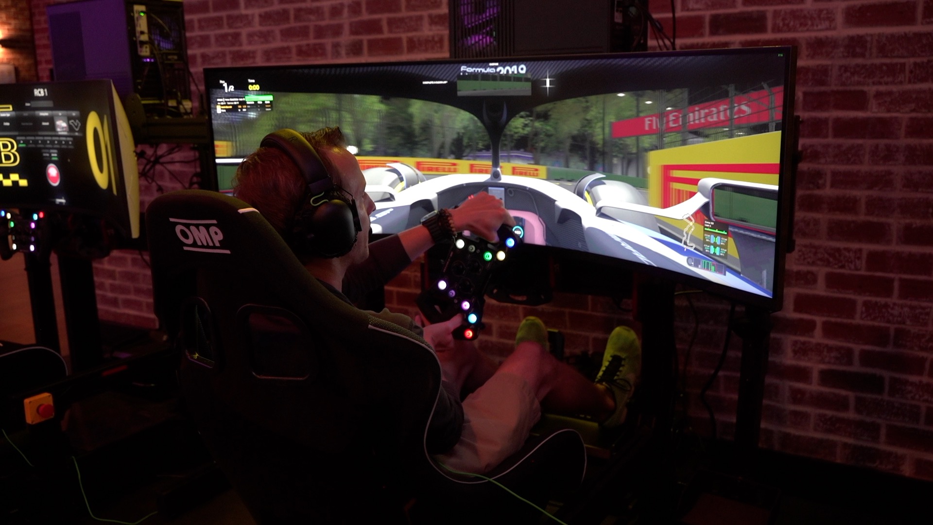 A driver uses a curved-screen racing simulator at Race Club Boise