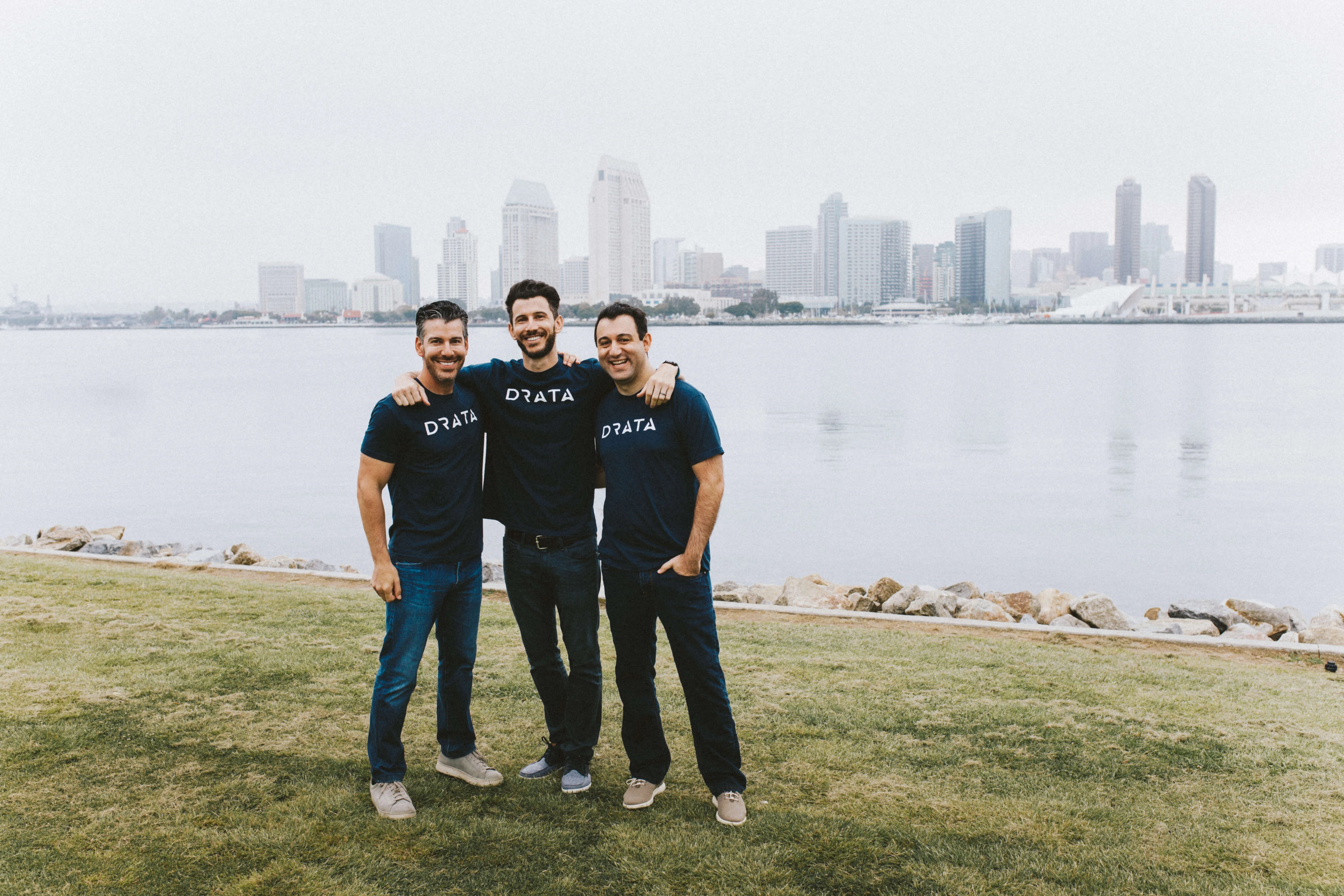Drata co-founders Troy Markowitz, Adam Markowitz and Daniel Marashlian standing together by the waterfront