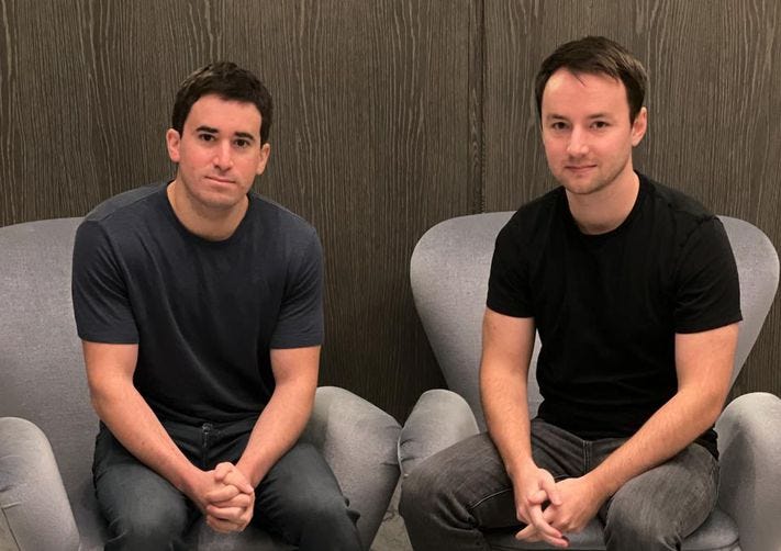 Adam Moelis, left, and Yotta co-founder Ben Doyle seated in gray armchairs