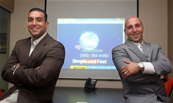 Adam Regiaba, left, and cofounder Arthur Atinizian standing in their Upfront Reputations office