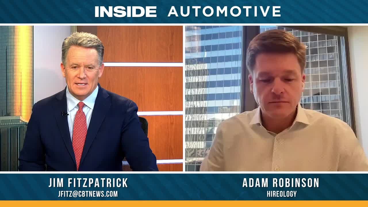 Adam Robinson speaking remotely with an automotive industry interviewer