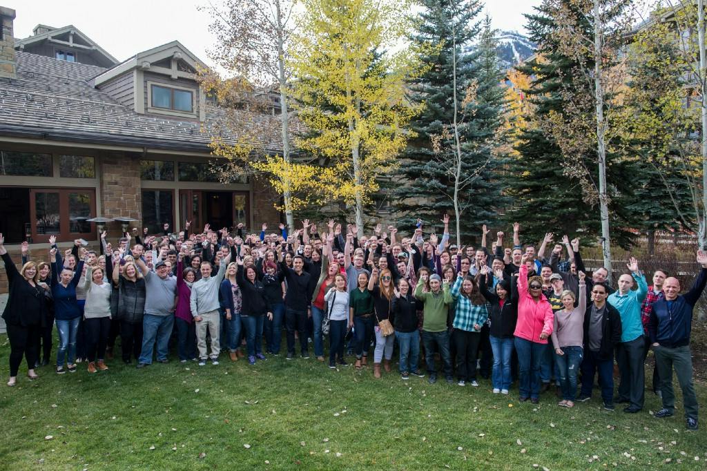 Articulate employees gathered outside among trees at a company retreat in Jackson Hole